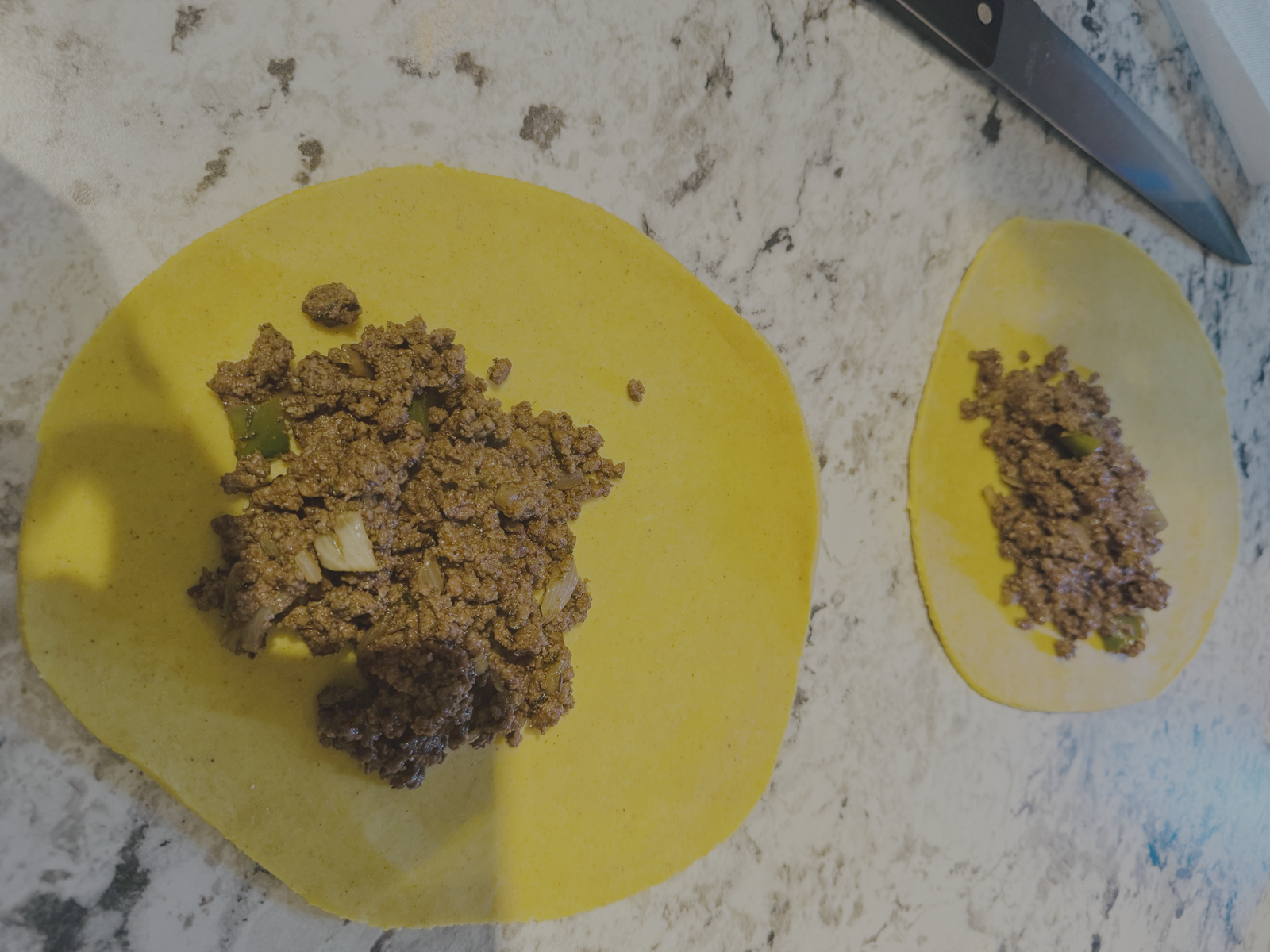 Beef filling added to dough circles ready to fold