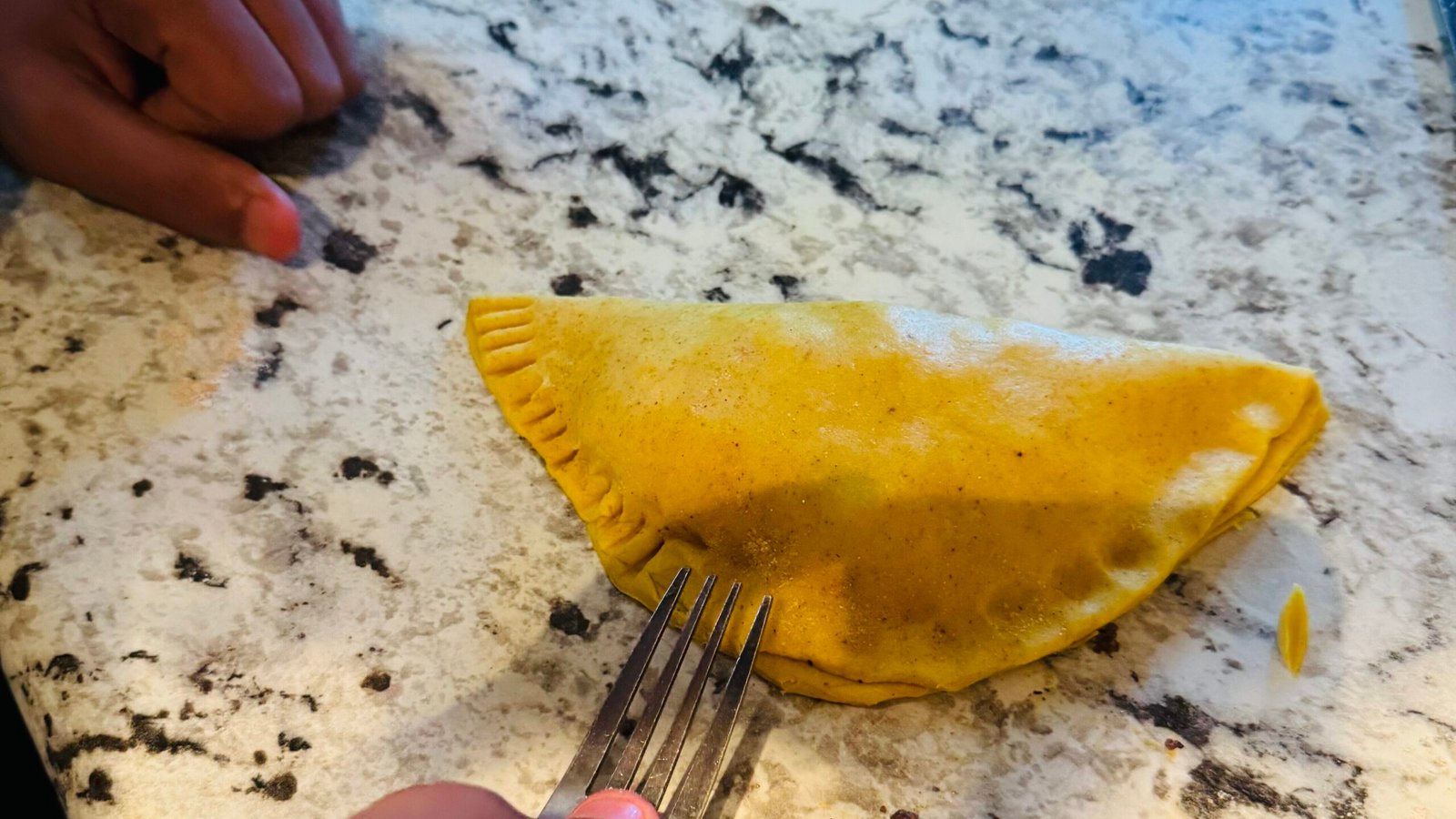 Crimping patty edges with fork to seal