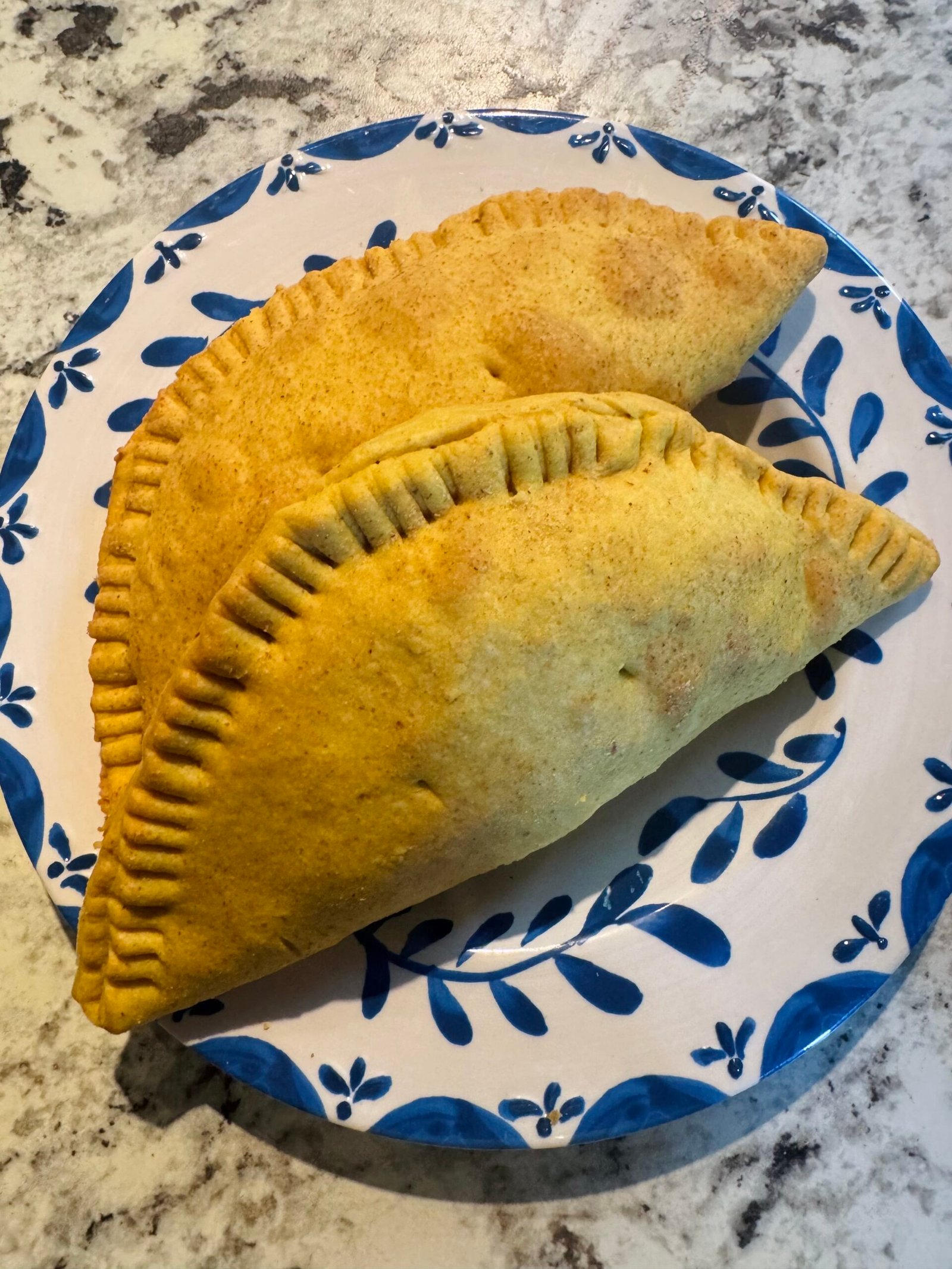 Final baked Jamaican beef patties on plate